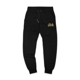 Black premium sweatpants with drawstring waist and gold dbk logo on the leg.