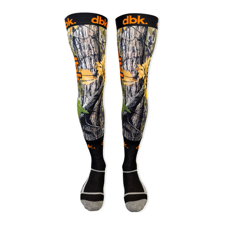 Pair of moto socks with gray camo print, yellow accents, green detail, black toe and heel