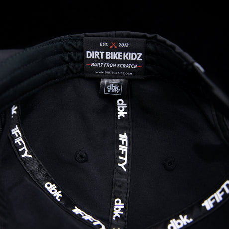 Black cap interior with Dirt Bike Kidz label and stitched panel seams.