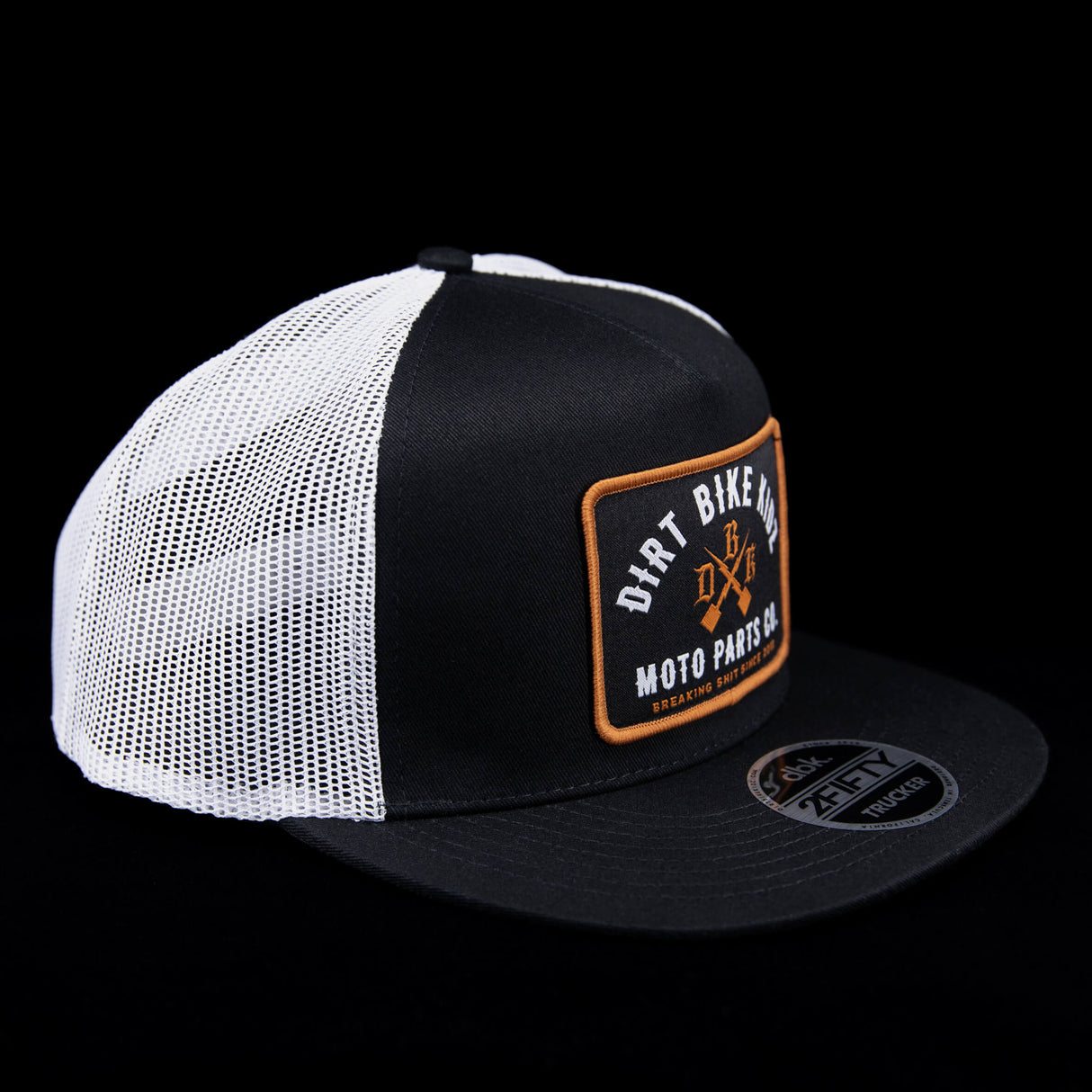Black and white mesh trucker hat with front logo patch and flat brim.