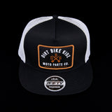 Black and white mesh trucker hat with front orange logo patch and 2FIFTY DBK label.