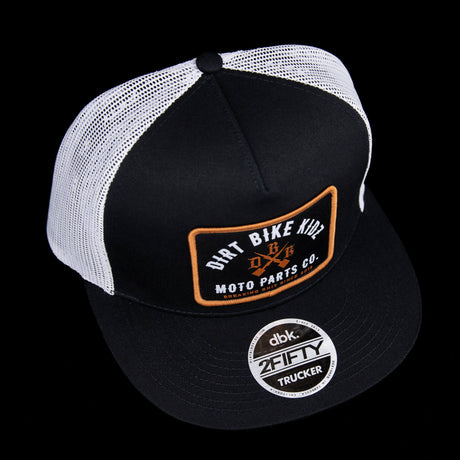 Black and white mesh trucker hat with orange front logo patch and DBK 2FIFTY badge.