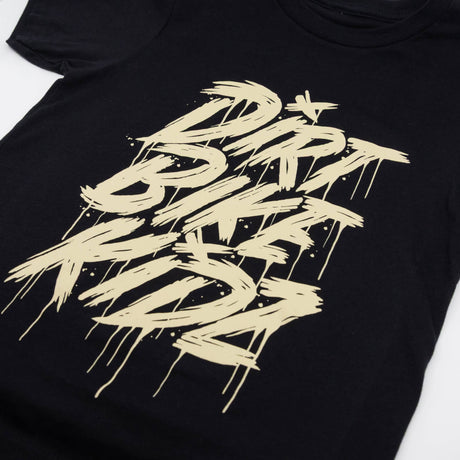 Black youth tee close-up with beige DRRT BIKE RIDE graphic across chest.