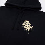 Black hoodie hood with drawstrings and small gold logo graphic