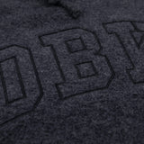 Women’s dark charcoal pullover hoodie extreme close-up of front logo graphic