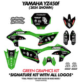 Green and black moto bike graphics kit parts, including side panels and tank cover pieces