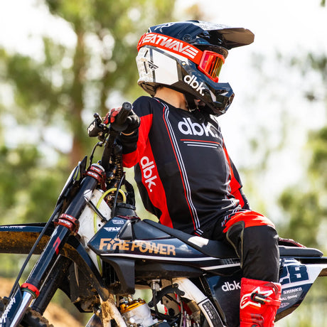 Youth motocross jersey with abk-style lettering, black body, red side panels, long sleeves