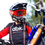 Youth riding jersey with black front panel, red sleeves, and striped accents, long sleeves