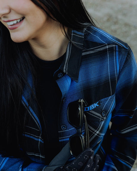 Women’s blue-and-black plaid flannel shirt with button-front and chest patch
