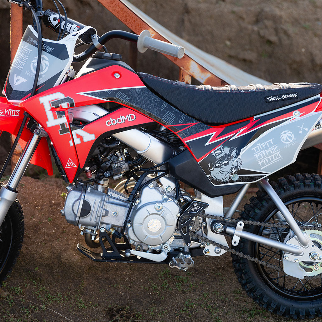 Honda CRF 110/50 signature kit side panel detail on red, black, and white bike