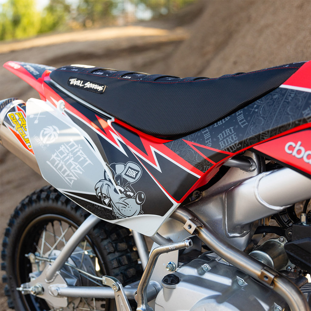 Motorcycle seat and side fairing with black fabric and red/white graphic designs