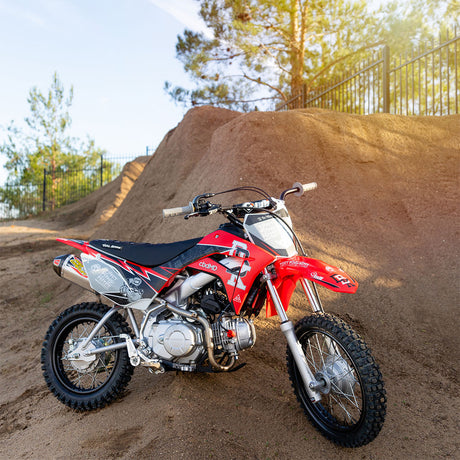 Honda CRF 110/50 dirt bike with red, black, and white signature graphics
