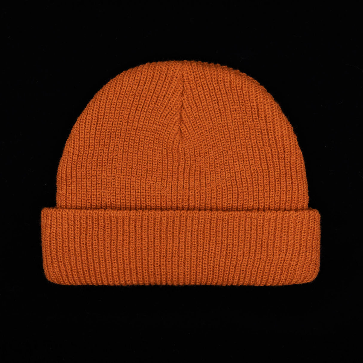 Rust orange knit beanie with ribbed cuff and smooth ribbed body