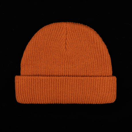 Rust orange beanie with folded ribbed cuff and smooth knit crown