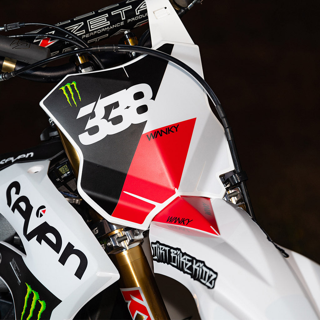 Graffiti-style die-cut sticker applied to a motorcycle front panel