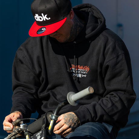 Black hoodie with hood up and small chest graphic logo