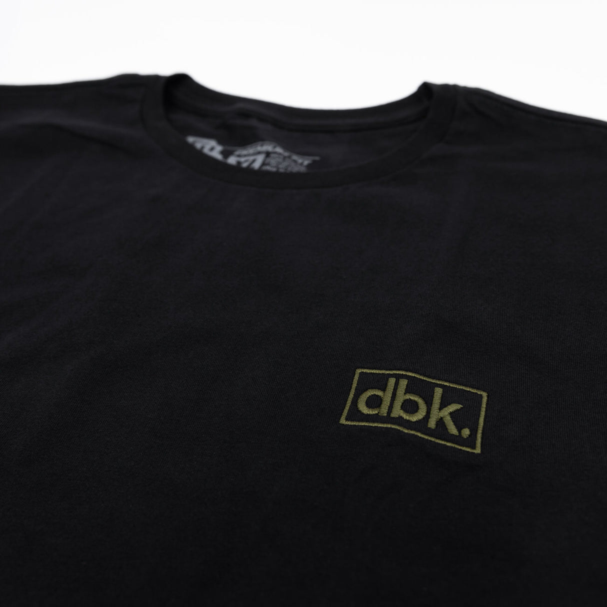 Black T-shirt close-up of dbk rectangular logo on chest