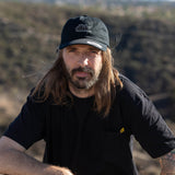 Black dbk dad hat worn by model with front logo patch