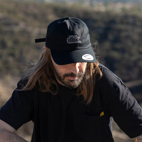 Black dad hat with dbk front logo and Adjustable side badge