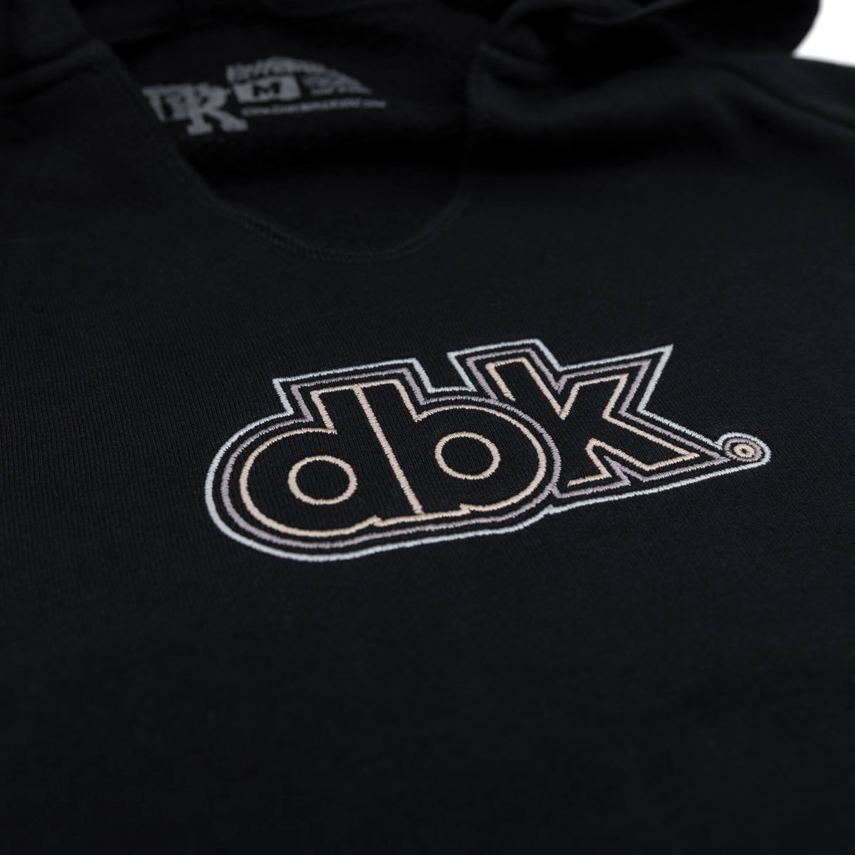 Black women’s hoodie with dbk graphic logo across the chest