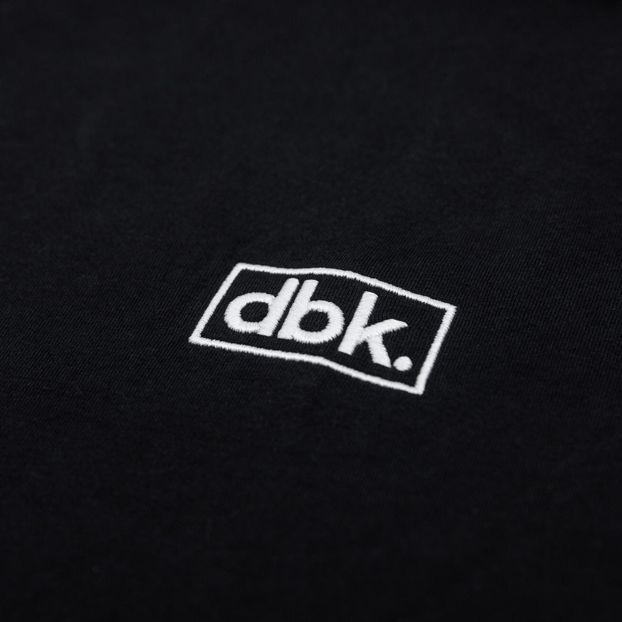 Black athletic tank fabric with embroidered dbk logo patch