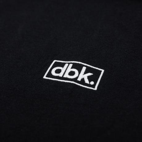 Black athletic tank fabric with embroidered dbk logo patch