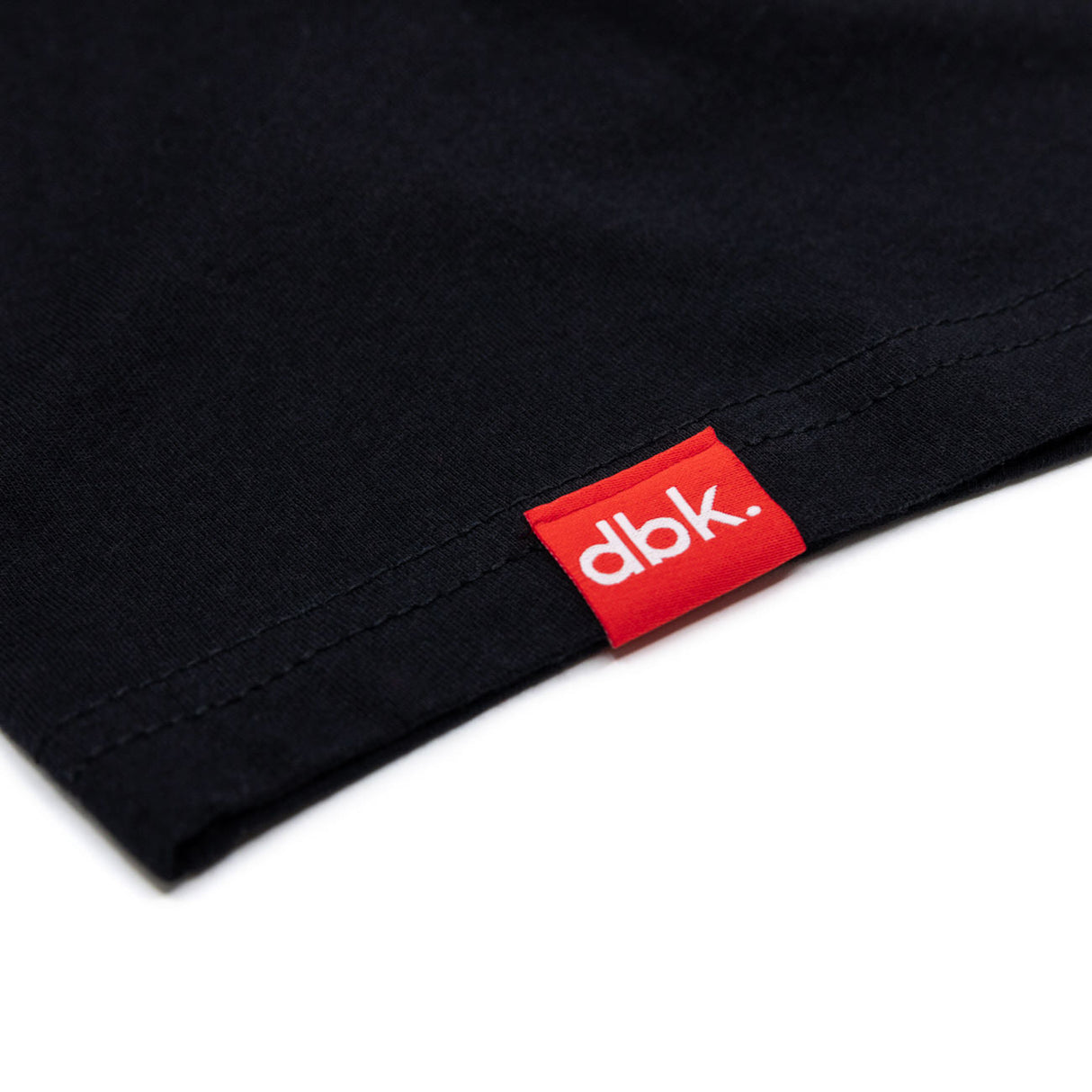 Black athletic tank hem with red dbk brand label