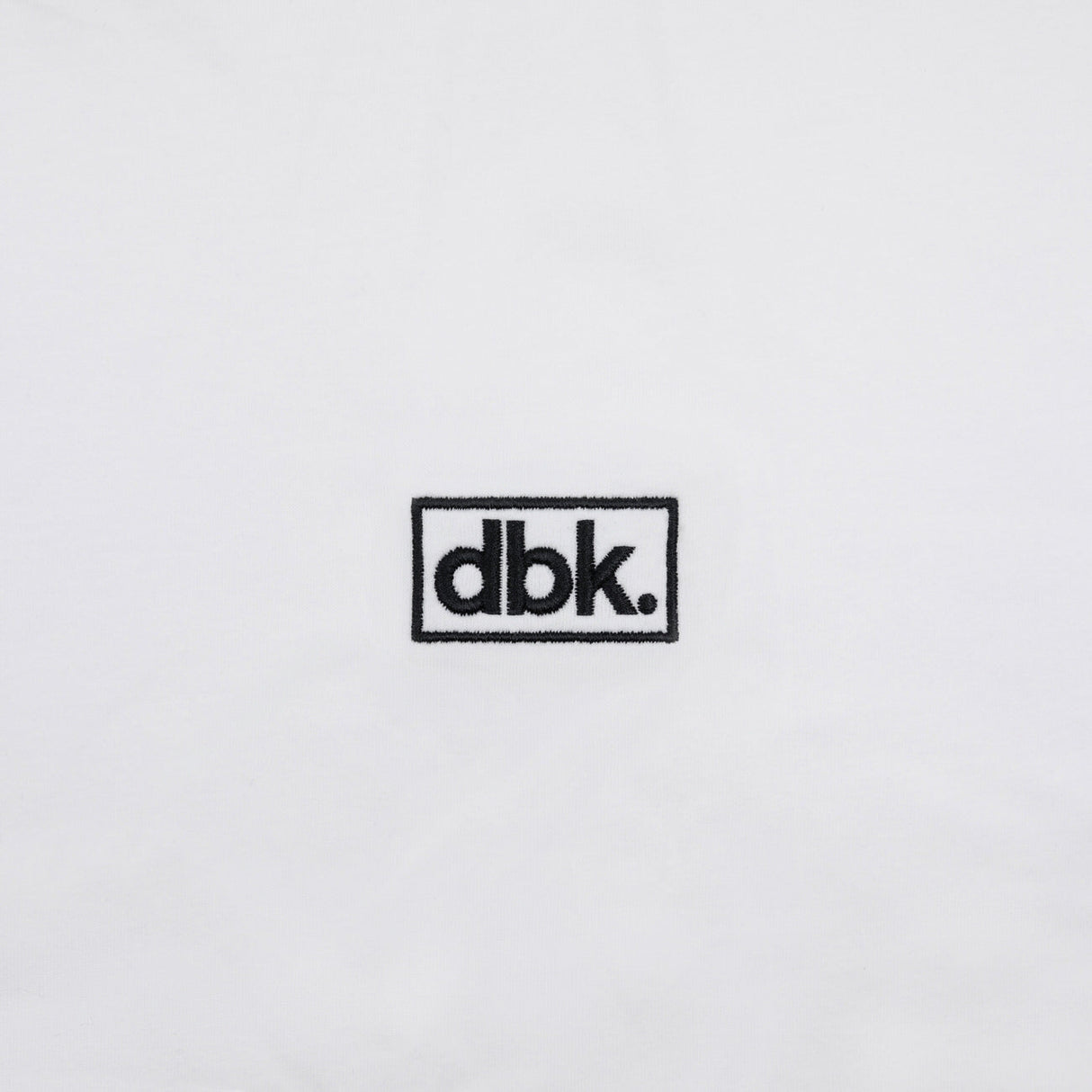 White athletic tank fabric with small dbk rectangular logo patch