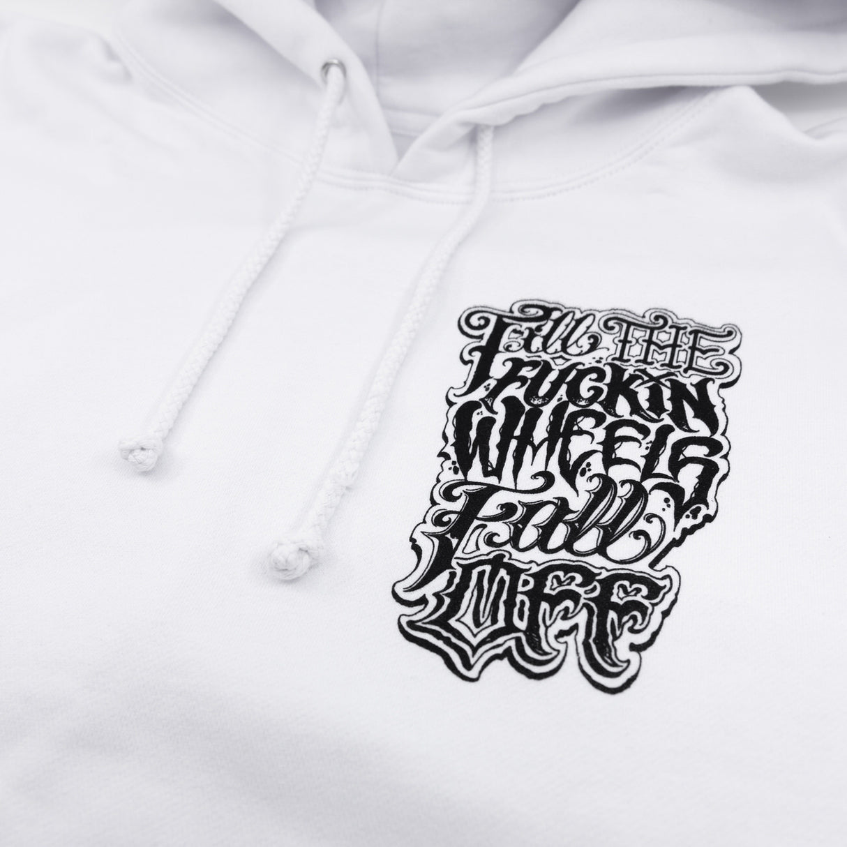 White hoodie detail: front graphic print near the chest with drawstring hood.
