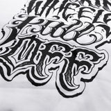 White hoodie close-up of white-and-black distressed word graphic on chest