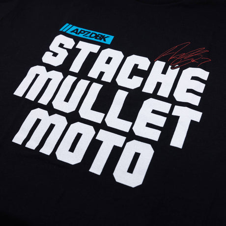 Youth premium tee, black, close-up of “STACHE MULLET MOTO” text print with red scribble