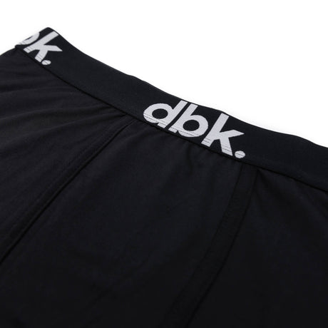 Black boxer briefs close-up of dbk logo on elastic waistband