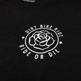 Close-up of black t-shirt chest logo: outlined rose in a circular badge