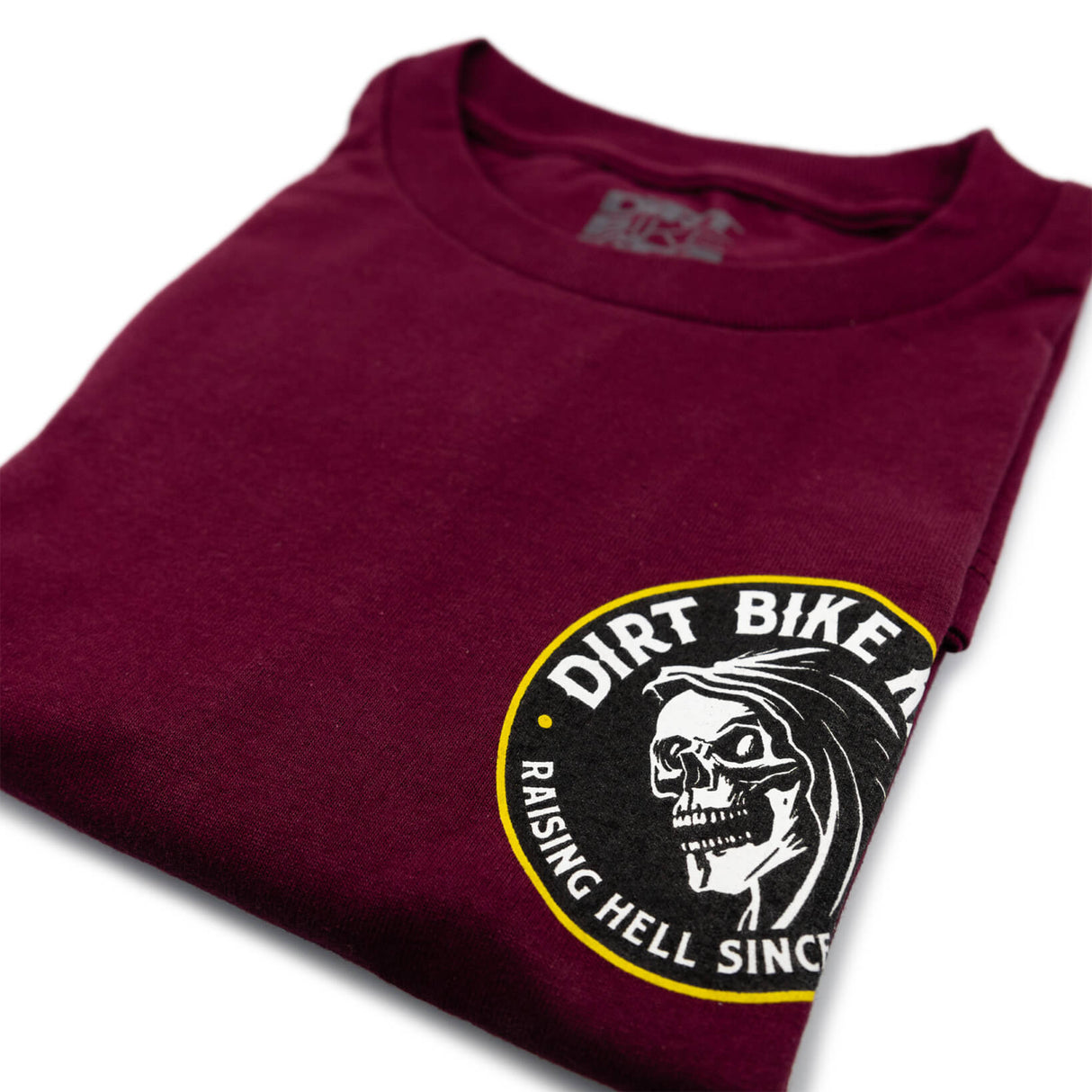 Reaper tee burgundy close-up, small Dirt Bike Kingdom front logo near collar
