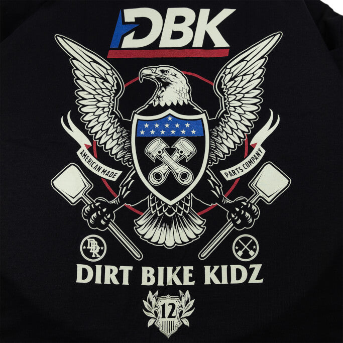 Black T-shirt close-up: DBK Dirt Bike Kidz eagle, stars, and crossed tools graphic.