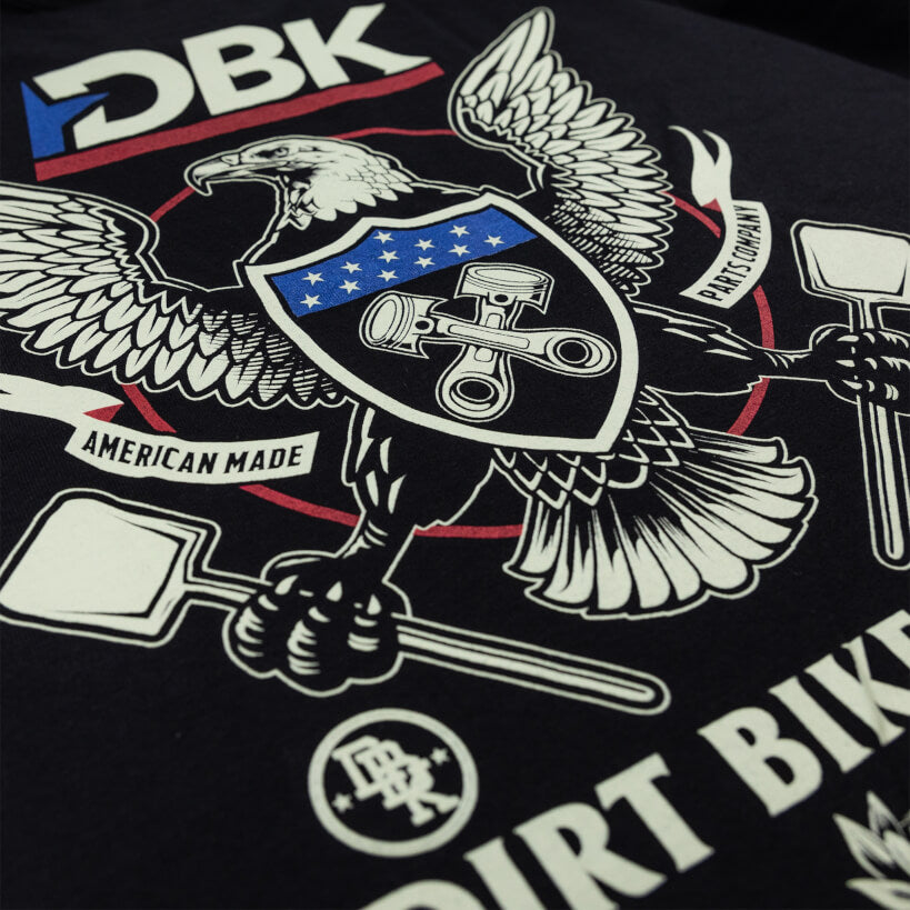 Black T-shirt close-up of DBK eagle artwork with swords, stars, and bold text.