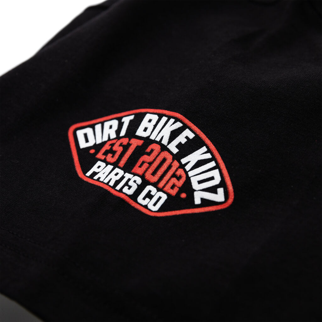 Black T-shirt close-up of Dirt Bike KIDZ Est. 2012 Parts Co. oval logo