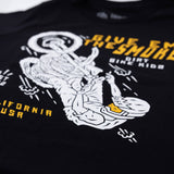 Close-up of black youth T-shirt front print with 'Give Em The Smoke' and rider graphic