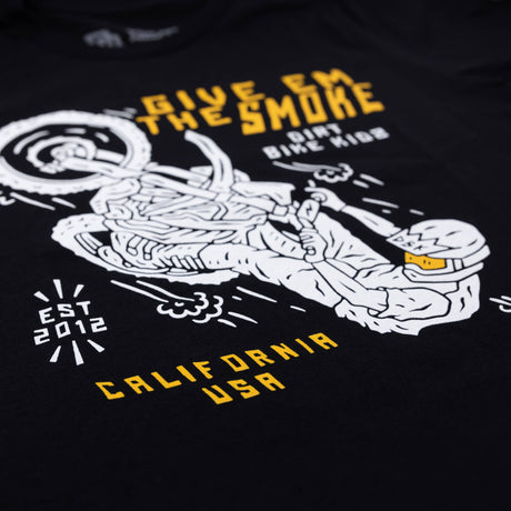 Close-up of black youth T-shirt front graphic featuring rider and 'Give Em The Smoke' text