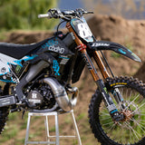 White and black racing wordmark decals on dirt bike body panel