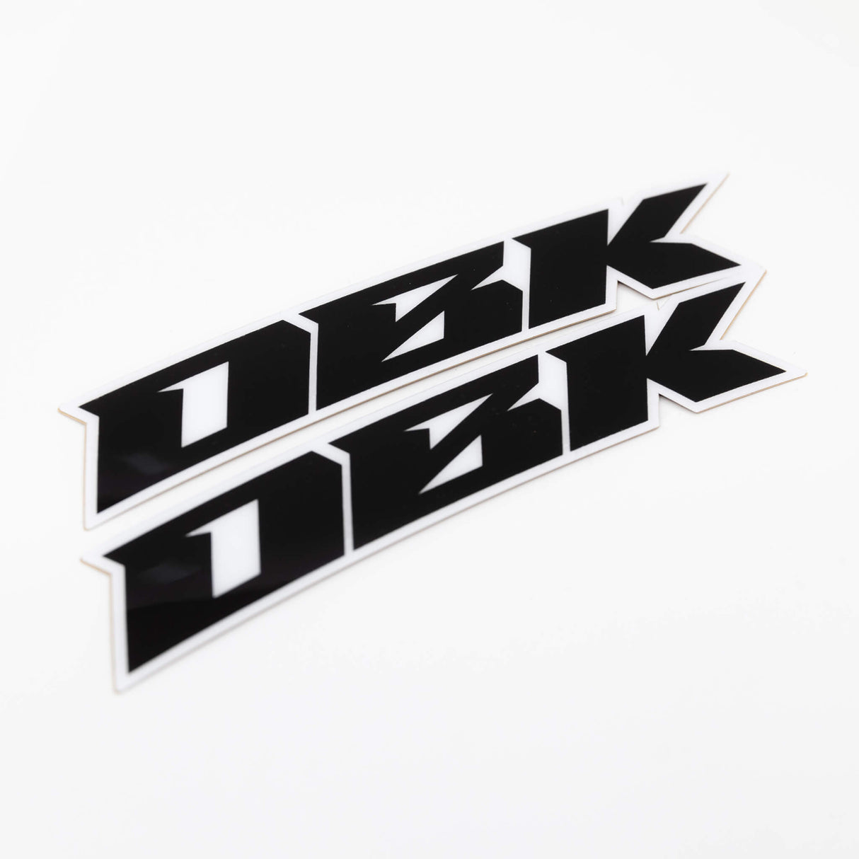 Close-up racer black fender sticker strip with bold black shapes and white border