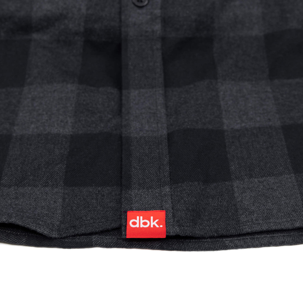 Charcoal plaid flannel shirt hem with red dbk label