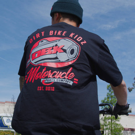 Black Factory Tee worn from behind with large DBK motorcycle logo on back.