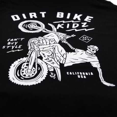 Close-up of black kids T-shirt back graphic featuring dirt bike and rider