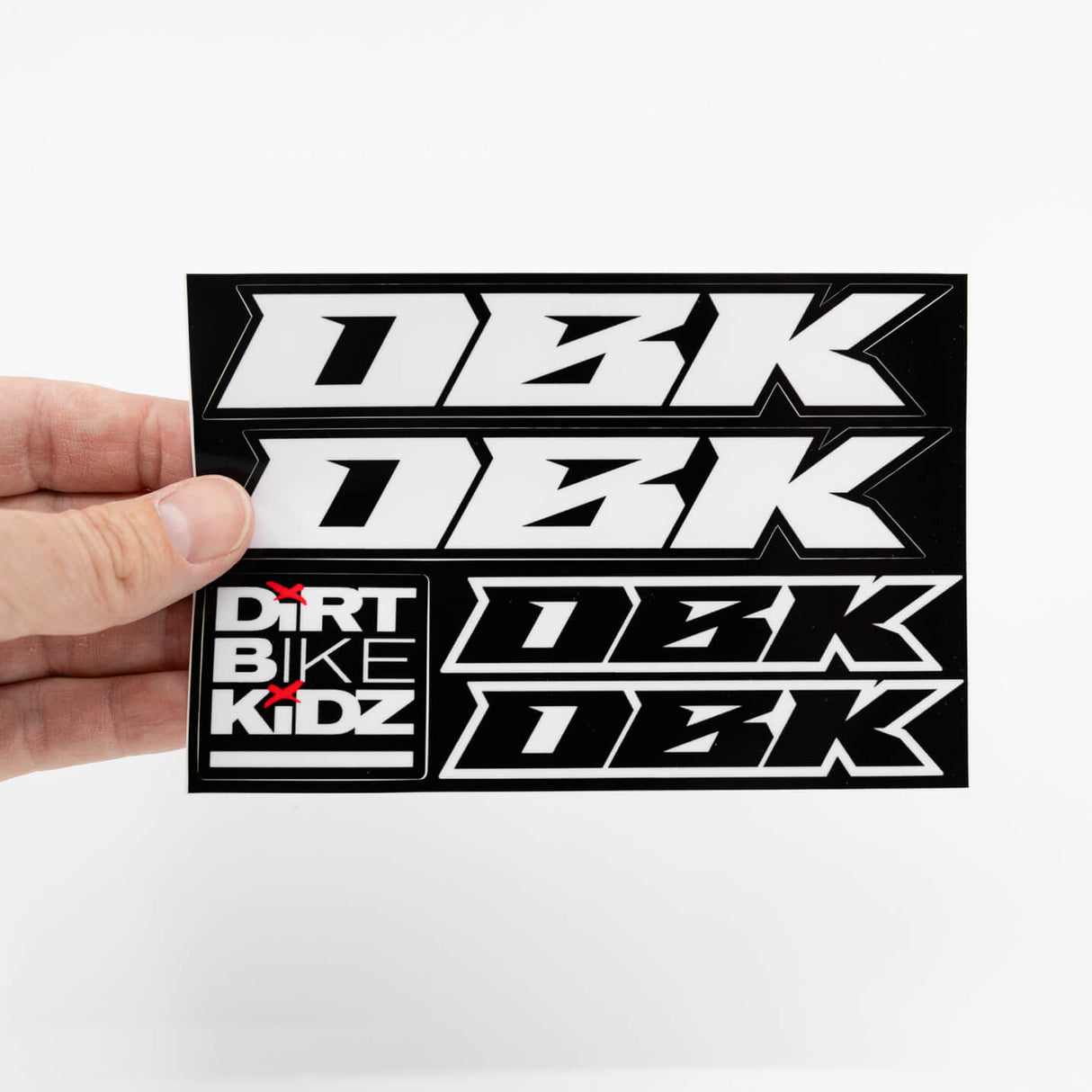Held sticker pack with black-and-white racing numbers and 'DIRT BIKE KIDZ' logo