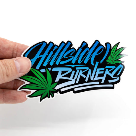 Sticker graphic with blue 'Hillside' text, green leaf icon, held in hand