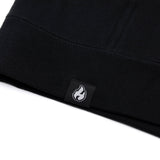 Black hoodie inner hem with small white flame logo woven label
