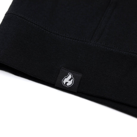 Black hoodie inner neck label with small flame icon patch