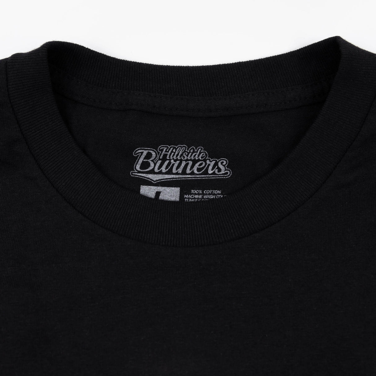 Black t-shirt neckline with Hillside Burners brand logo patch and neck seam.
