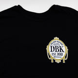 Black tall tee with DBK crest emblem on the chest.